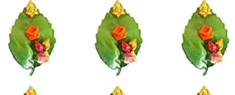 Creative Golu gift sets arranged on green leaves with tiny Ganesha figures and plastic kumkum-manjal sachets