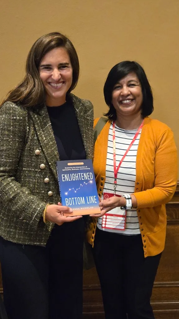 Subha with Jenna Nicholas and a signed copy of Enlightened Bottom Line